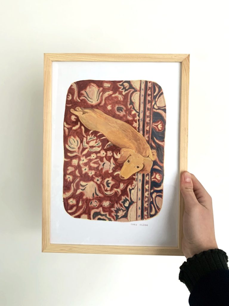 framed print of a longhaired dachshund on a Persian rug